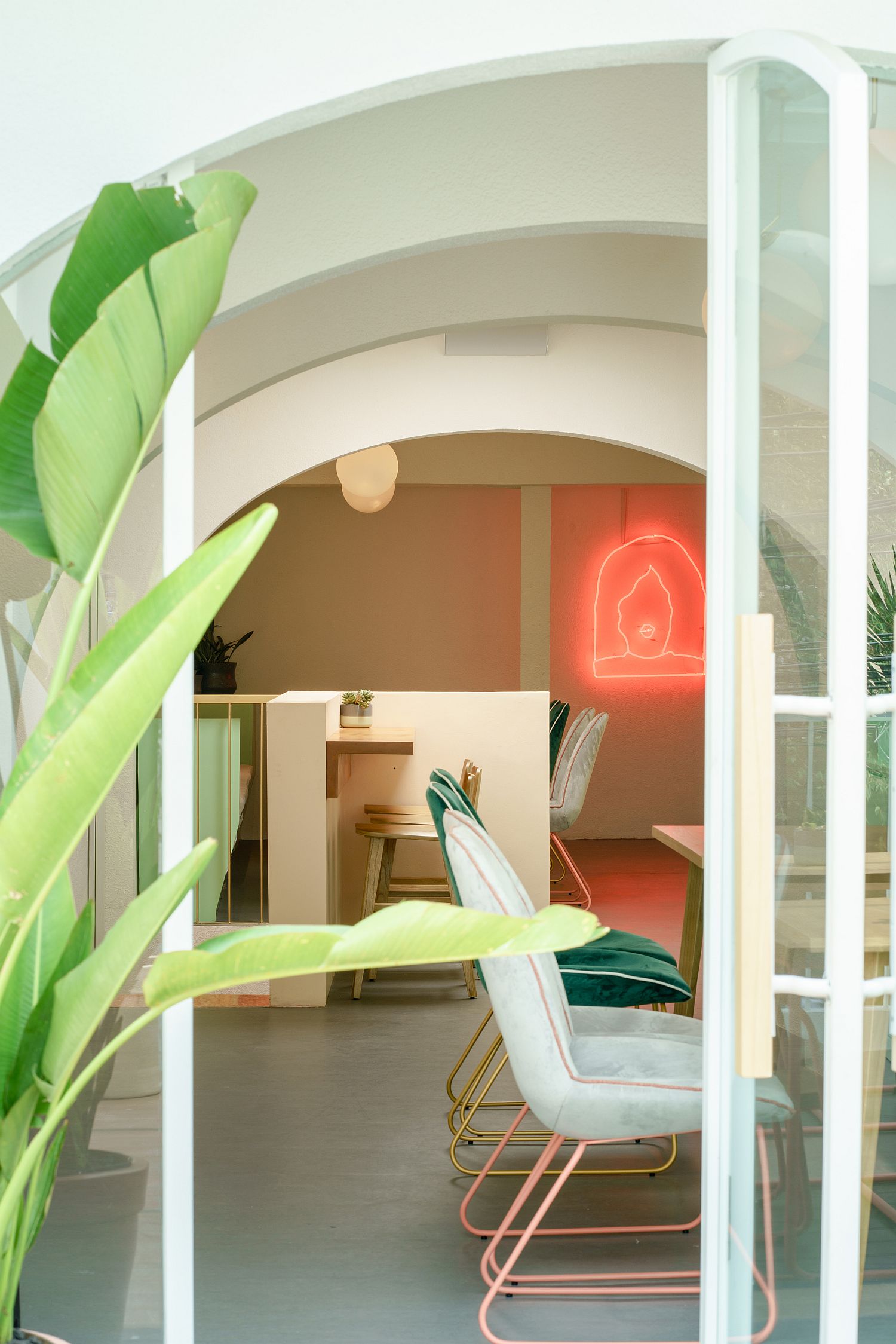 Neon lighting and greenery bring even more color to the cafe