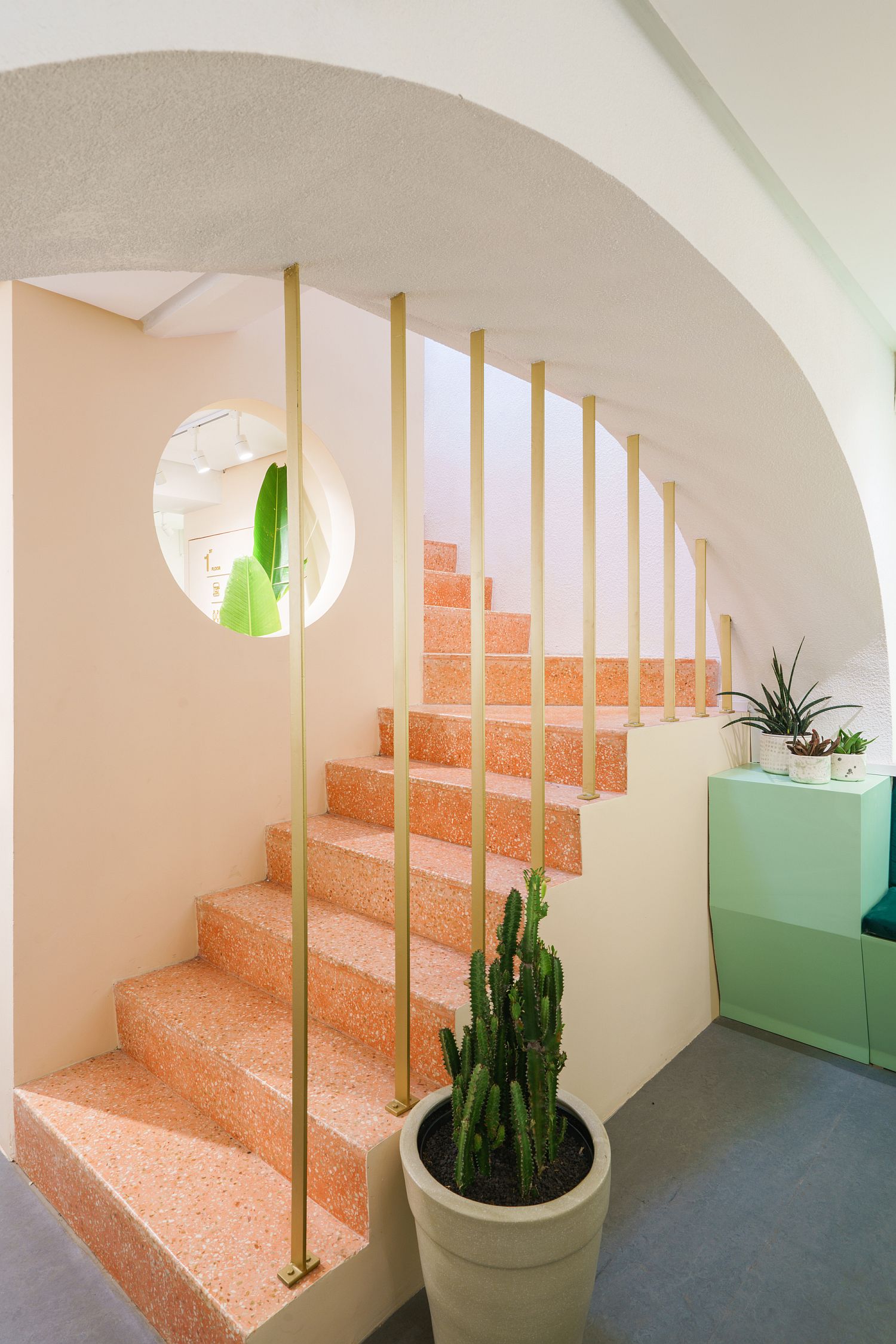 Pastel green and orange add brightness to the cafe interior