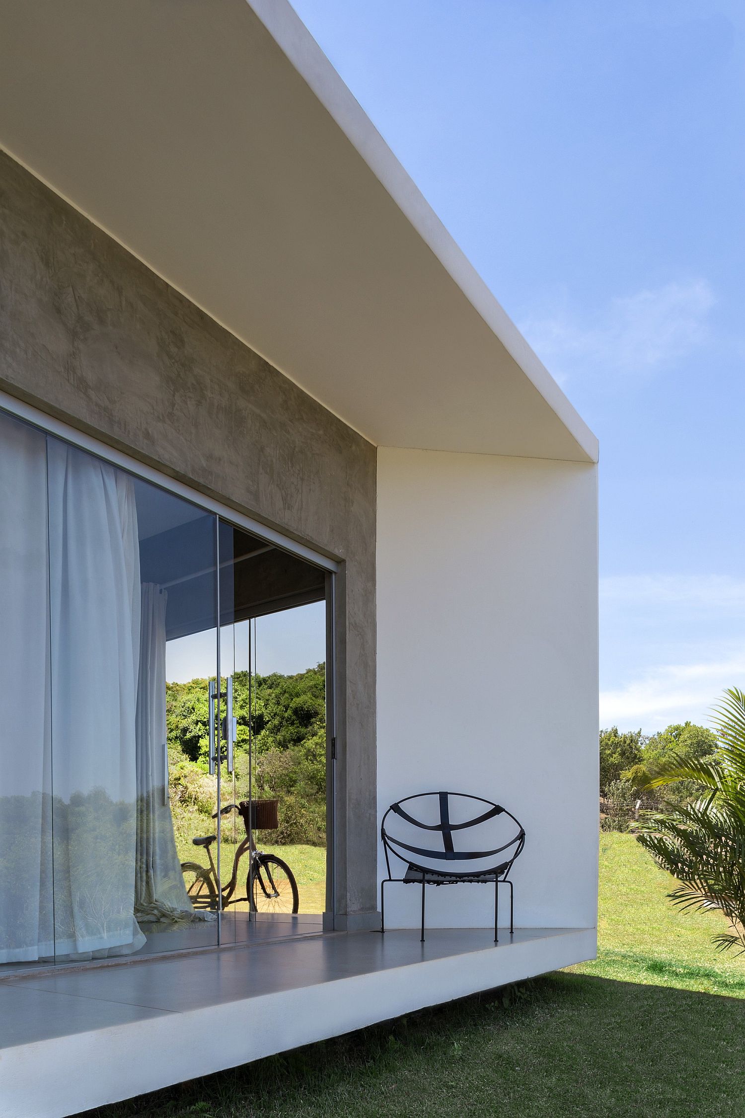 Sliding glass doors open up the living area to the greenery outside