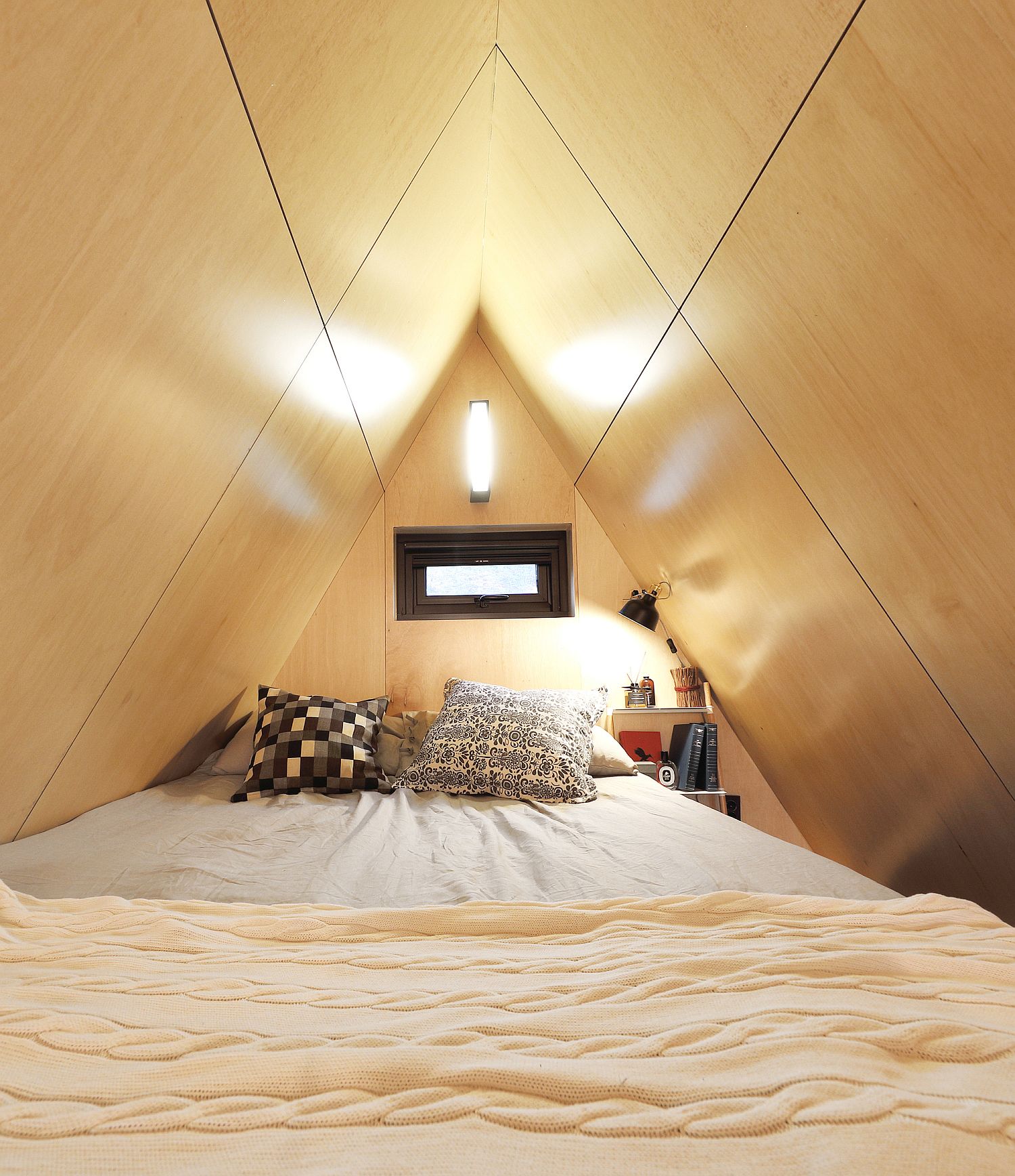 Space-savvy and woodsy bedroom of the tiny house with natural ventilation