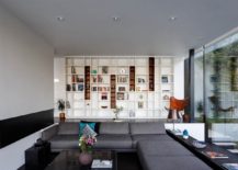 Sunken-living-room-with-large-gray-sectional-and-white-bookshelf-in-the-backdrop-217x155