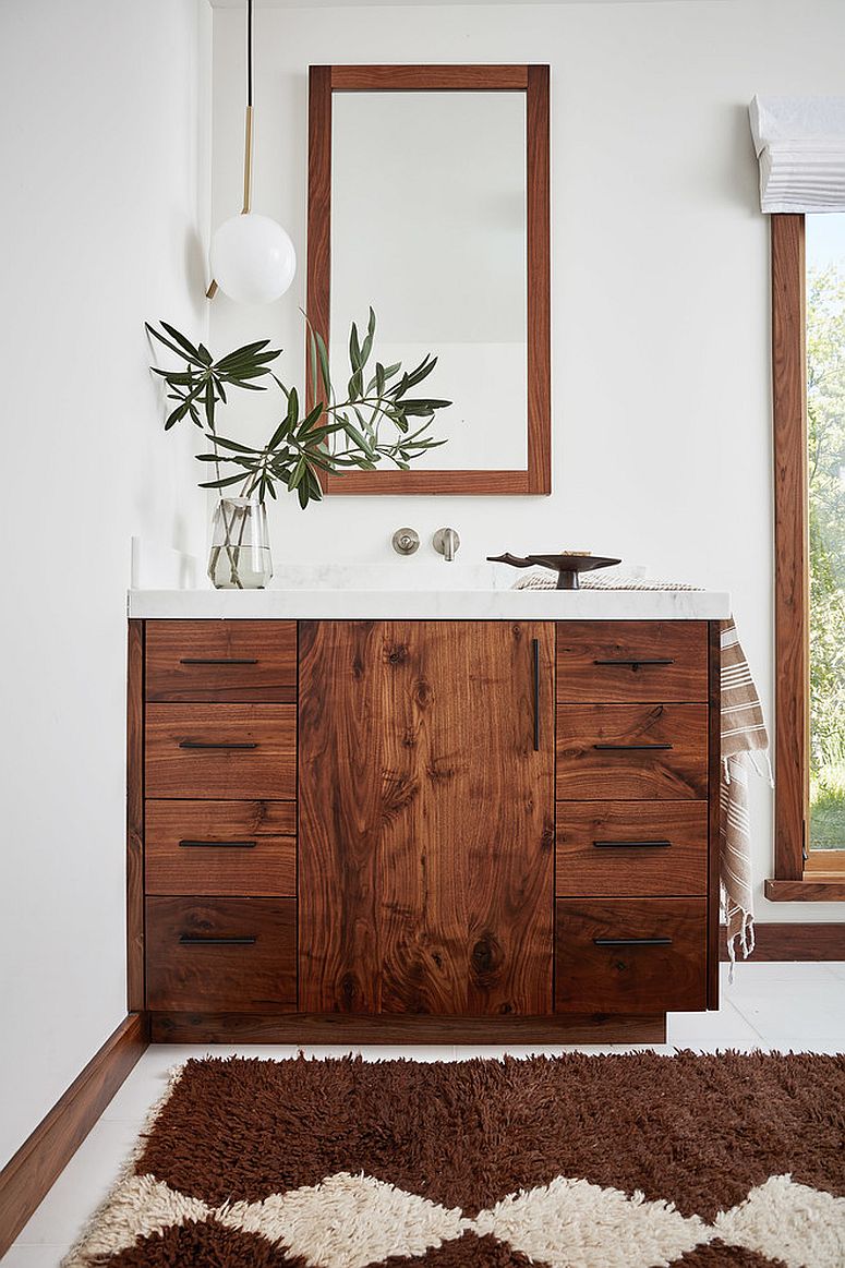 Vanity-and-mirror-frame-adds-woodsy-element-to-the-bathroom-in-white