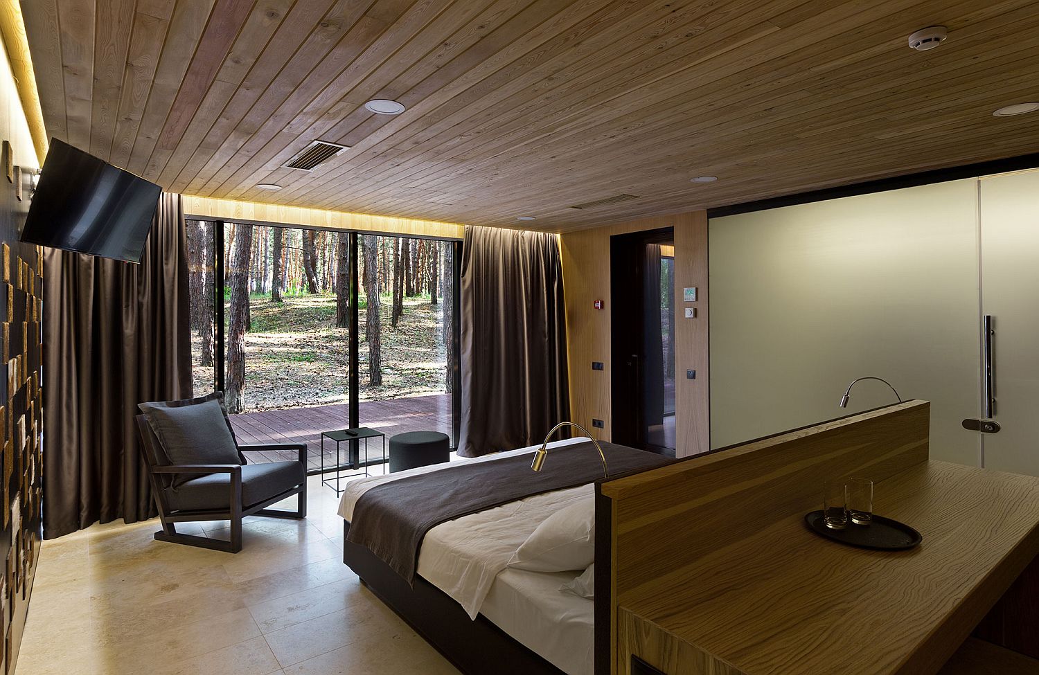 View of the pine forest outside from the bedroom of the Guest House