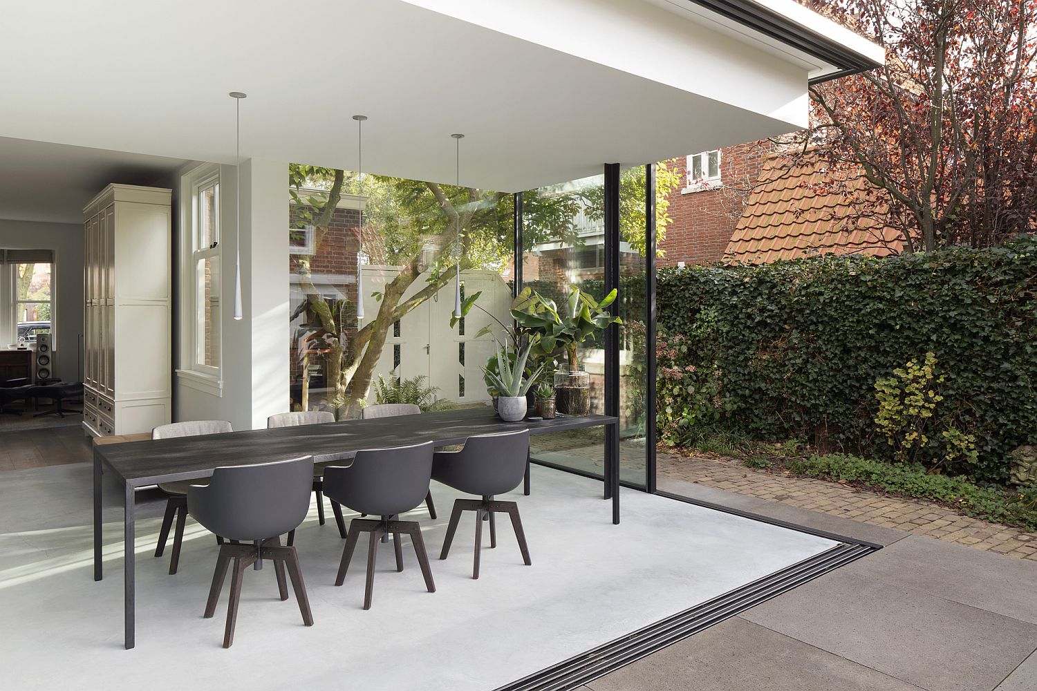 White and gray dining room connected with the Fig Tree landscape outside