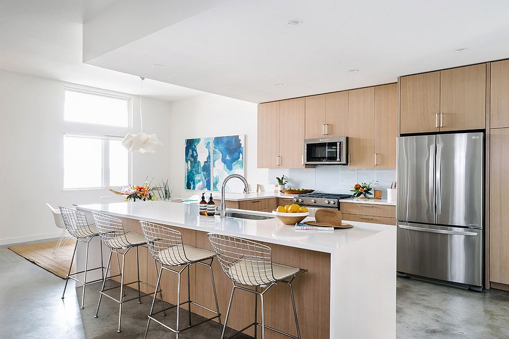 White and wood beach style kitchen with blue wall art in the corner