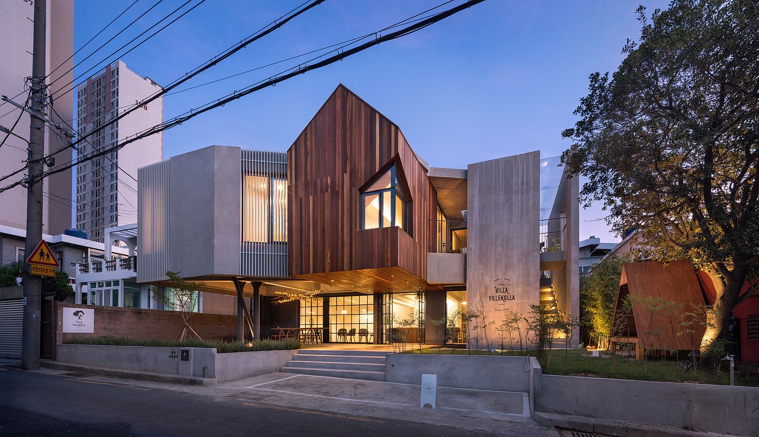 Wood and concrete along with cantilevered gable structure give the cafe home a unique look