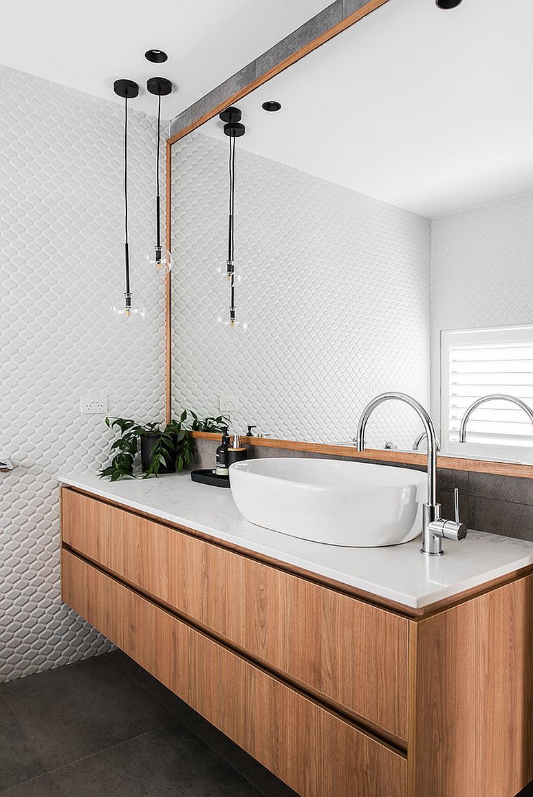 Wood brings warmth to the all-white bathroom with tiled backsplash
