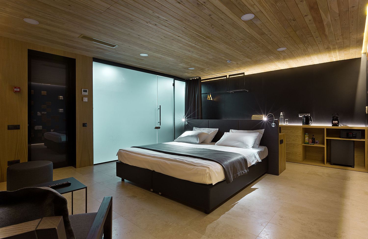 Wooden and modern interior of the Guest Houses give a warm shelter inside the pine forest