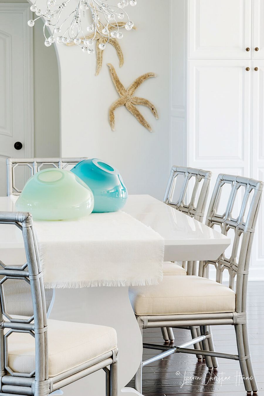 Coastal accents bring uniqueness to the dining space in white