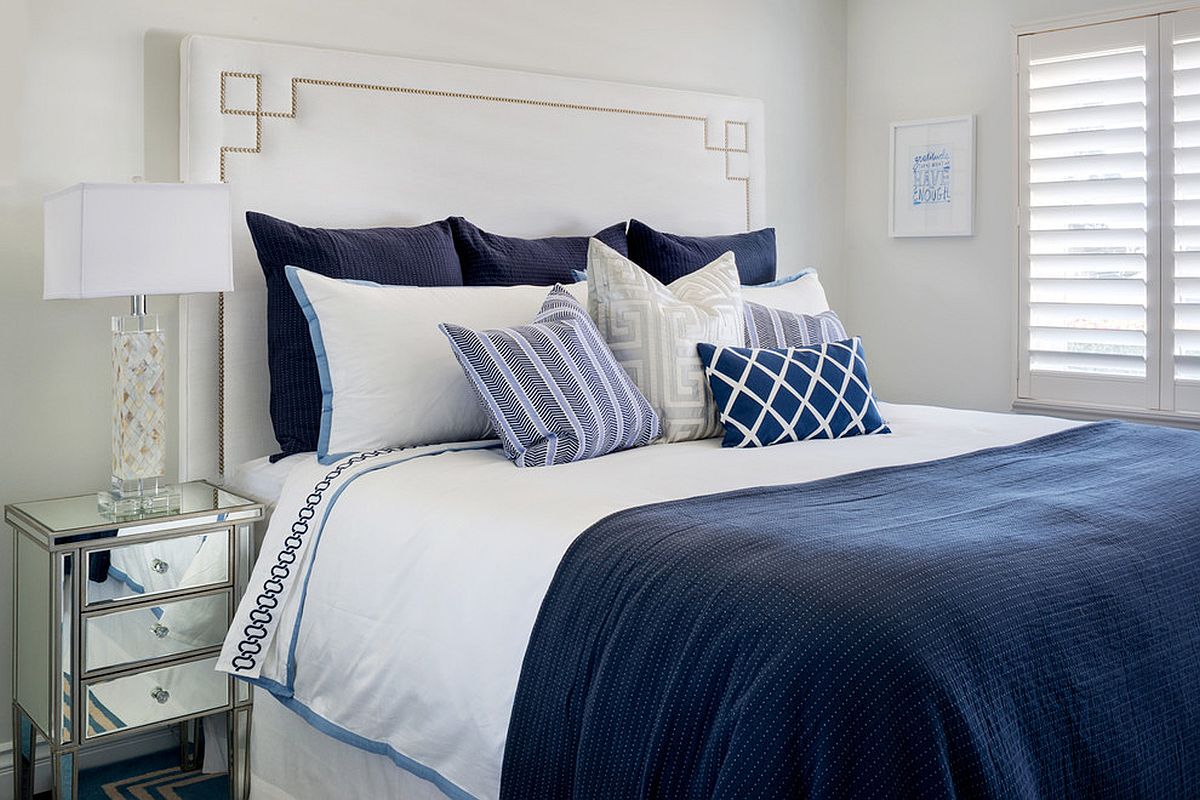 Coastal style bedroom in deep blue and white with lots of natural light