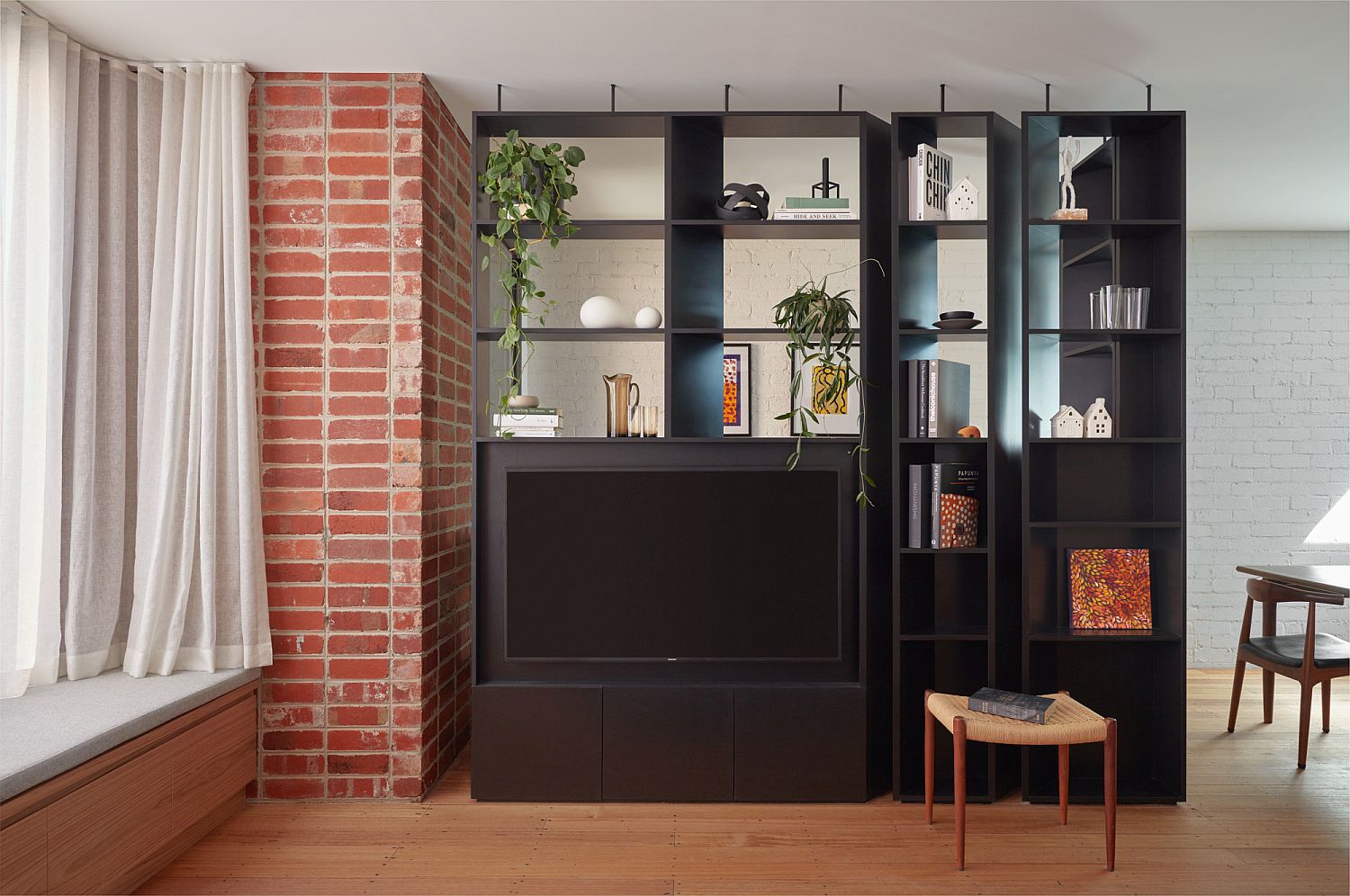 Custom-black-TV-unit-and-shelving-for-the-living-space