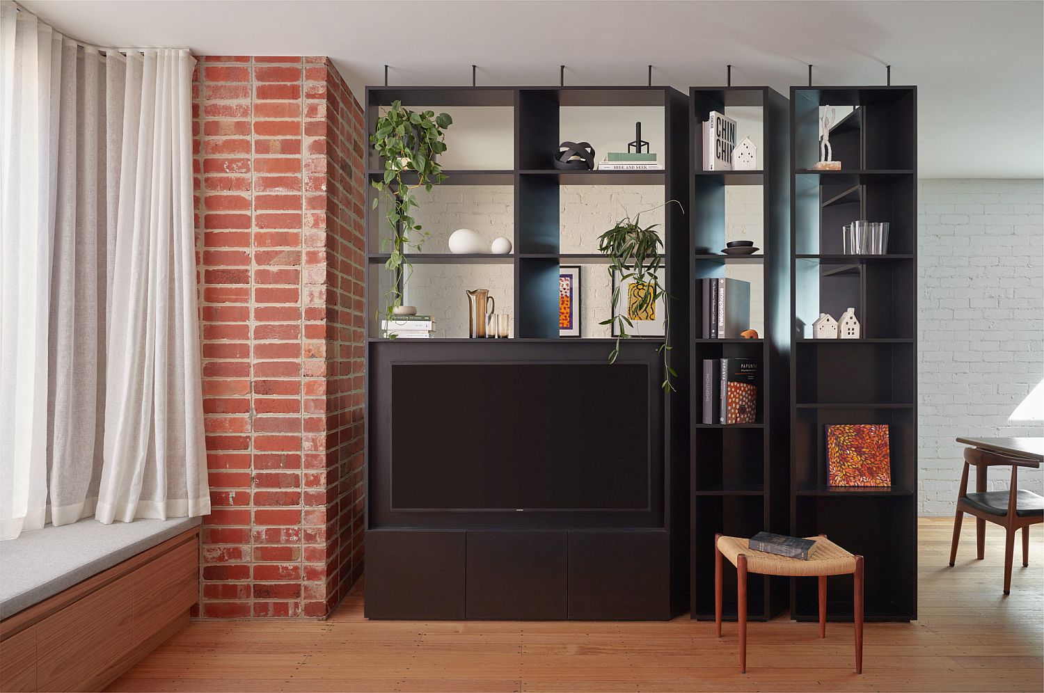 Custom black TV unit and shelving for the living space