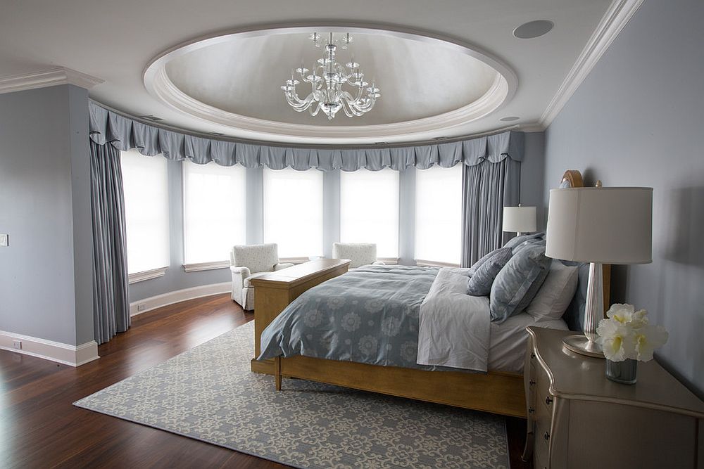 Drapes add both functional and aesthetic value to this circular bedroom