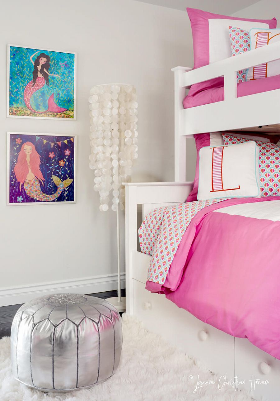 Girls' bedroom in white and pink with coastal themed additions on the wall