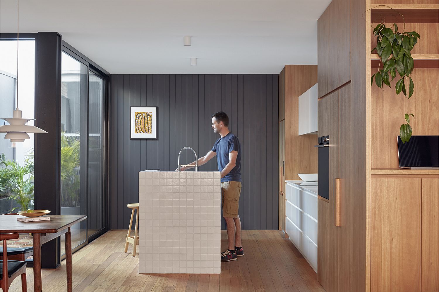 Gray accent wall brings sophsitication to the kitchen in white and wood