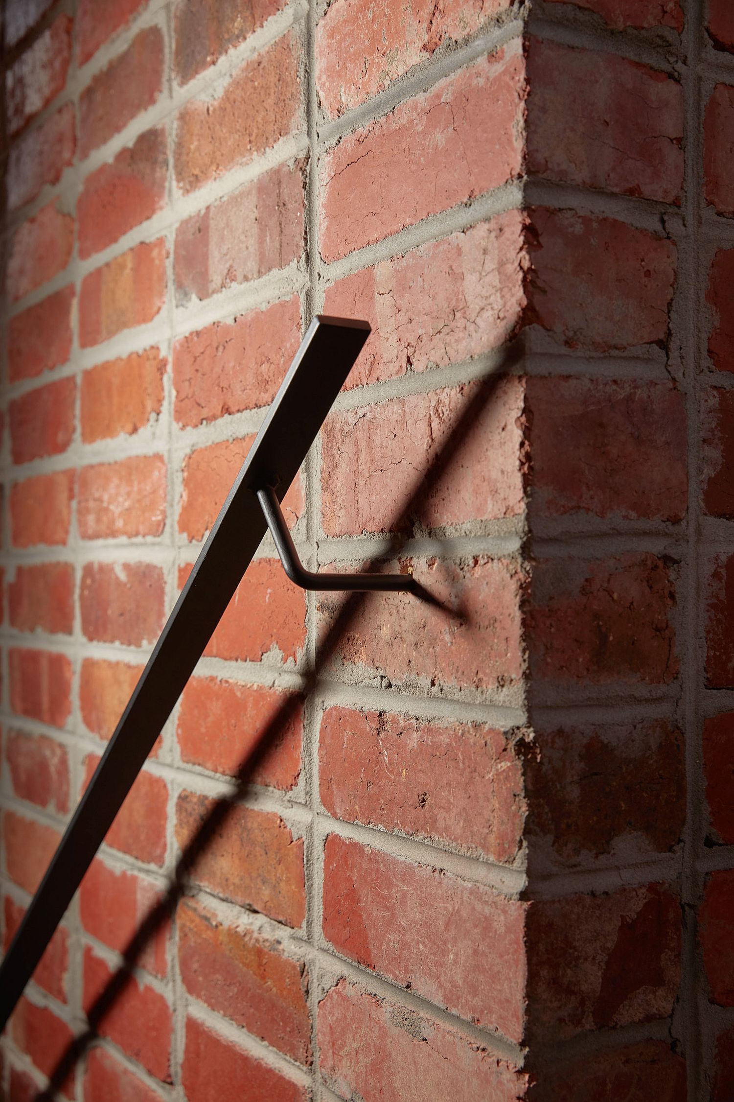 Metallic railing for the staircase inside the brick house