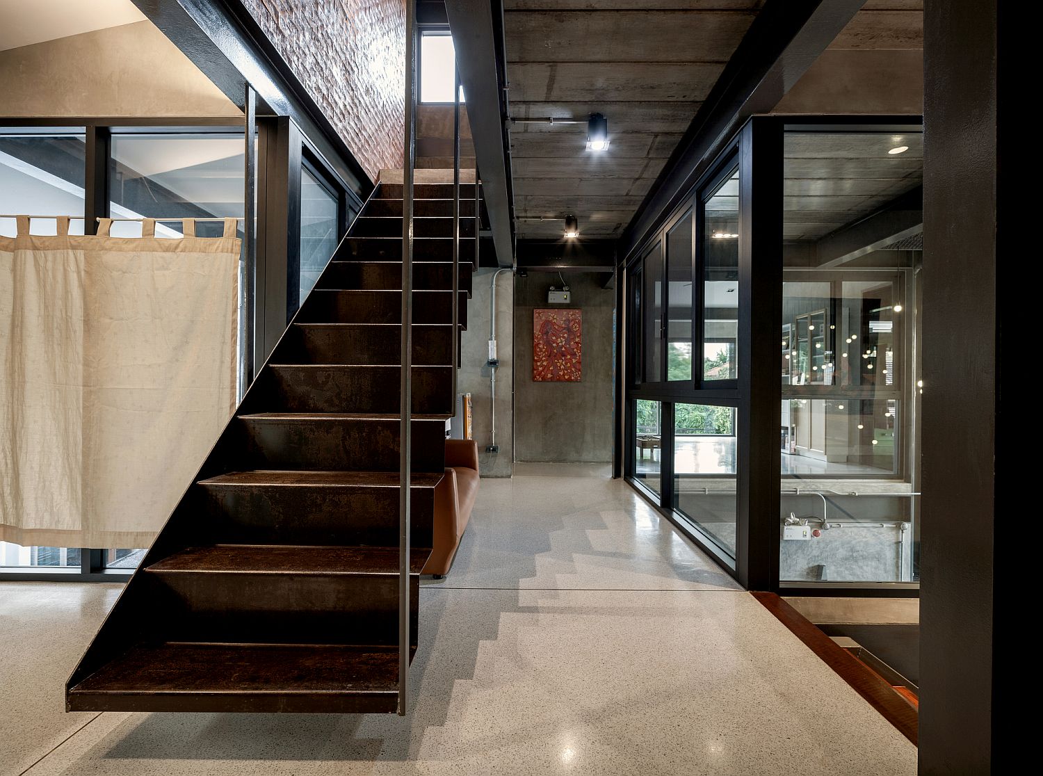 Metallic stairway along with simple industrial style lighting