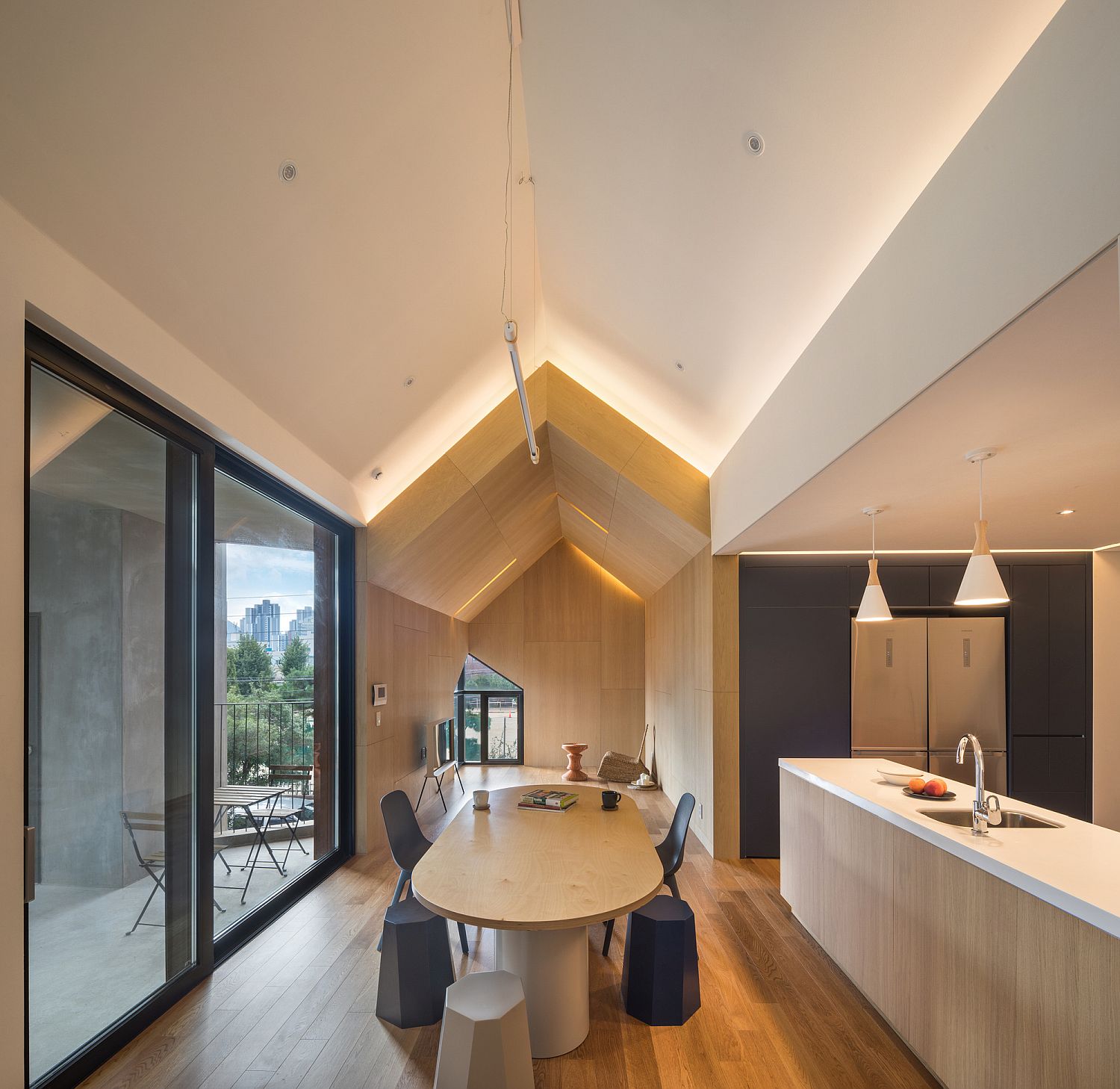 Minimal Scandinavian style kitchen and dining area with black and wood