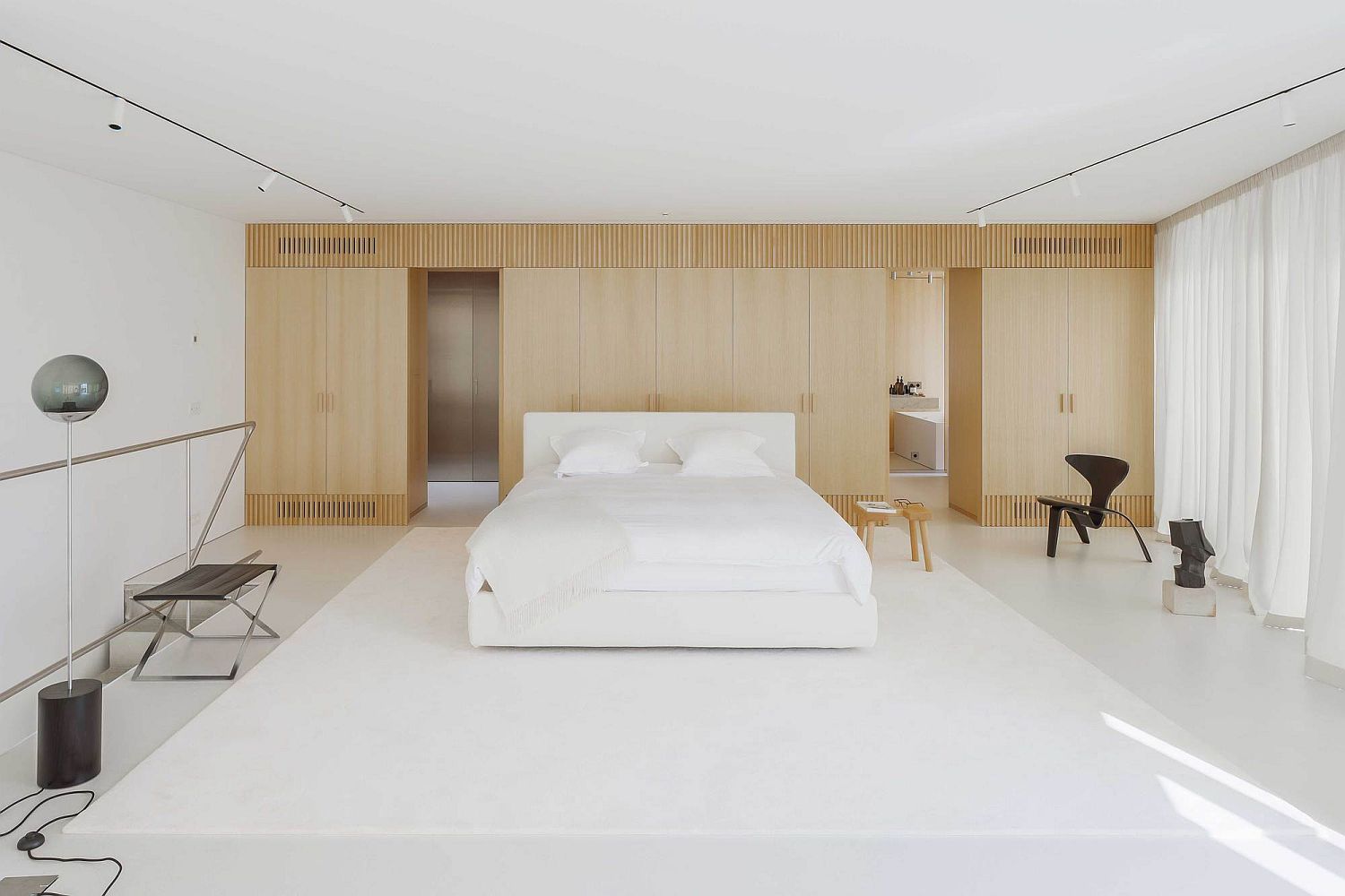 Minimal-bedroom-in-white-with-wooden-accent-wall