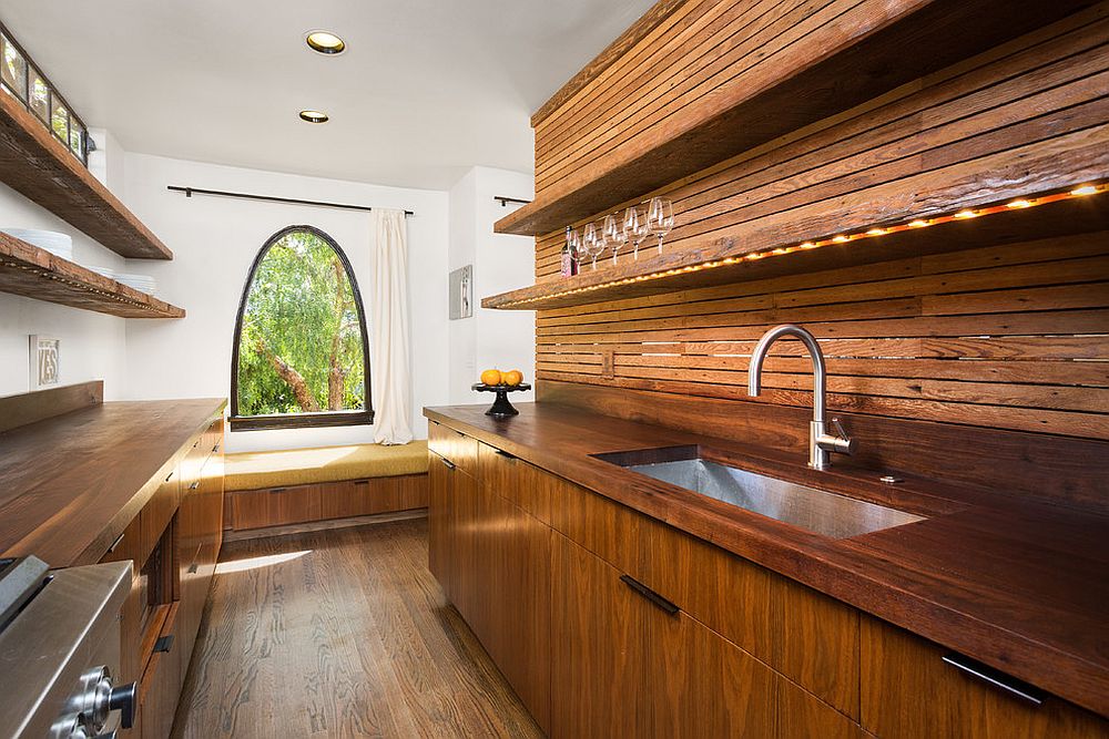 Narrow and woodsy contemporary kitchen with window seat at its end