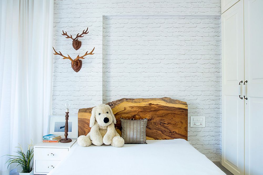 Natural wood headboard adds warmth and elegance to this lovely kids' room in white