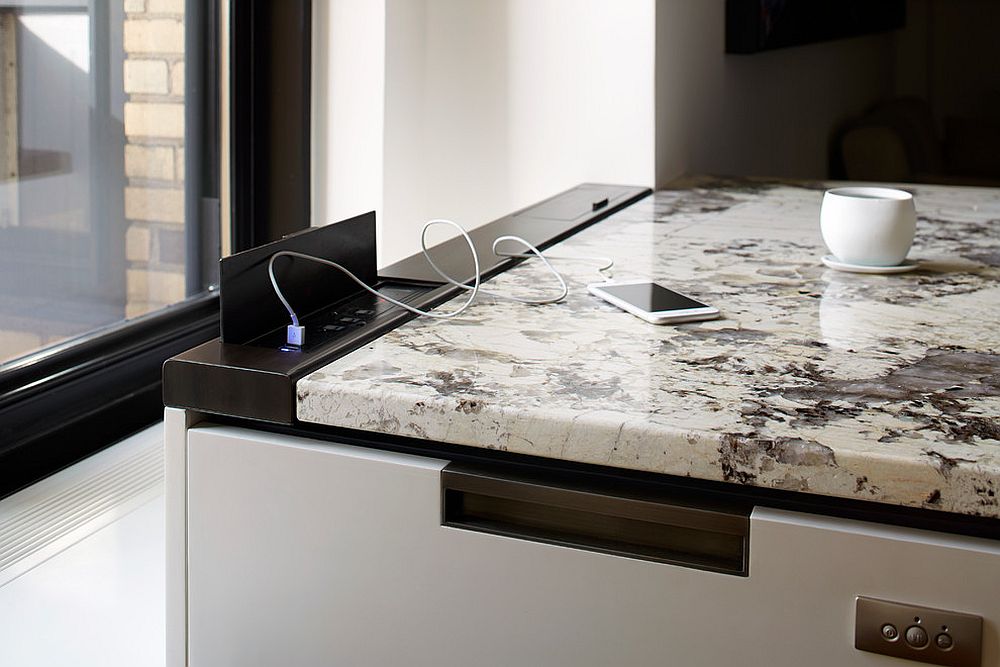 Oxidized-metal-enclosure-provides-the-charging-ports-in-this-uber-contemporary-kitchen