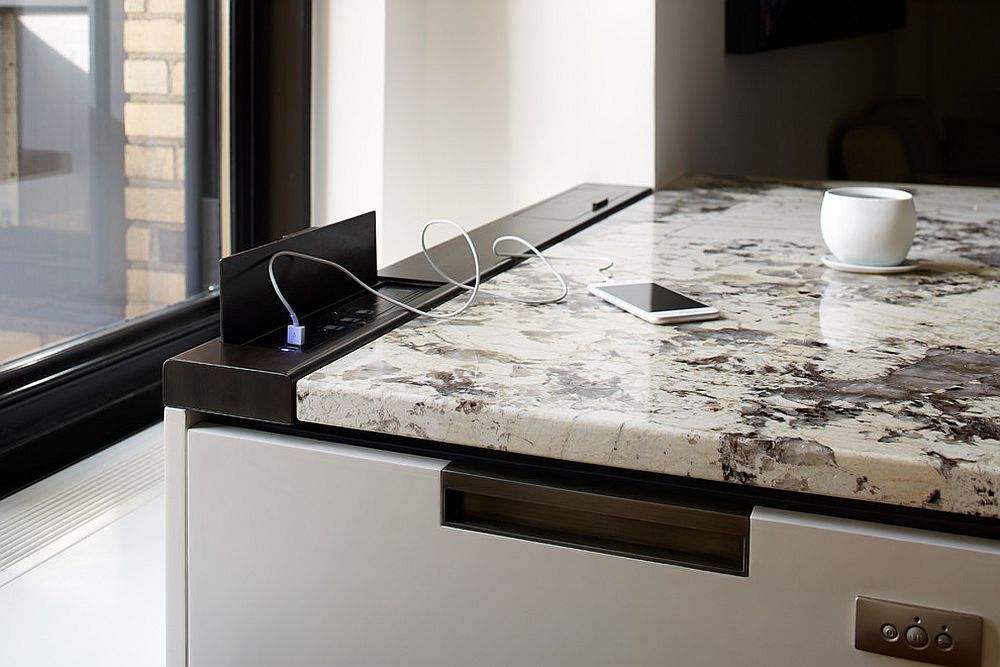 Oxidized metal enclosure provides the charging ports in this uber-contemporary kitchen