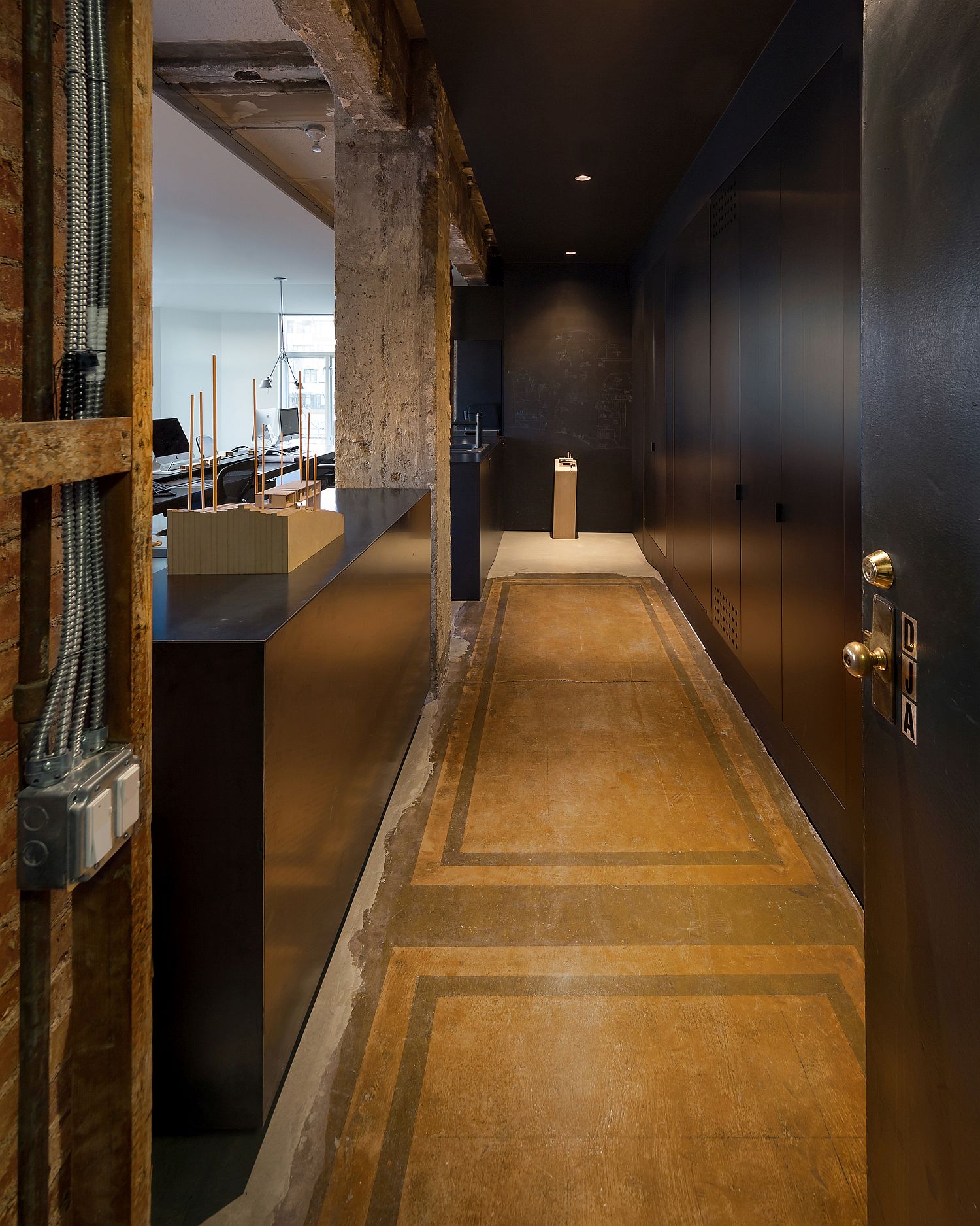 Raw steel, concrete and custom fixtures along with monolithic cabinets for the home office