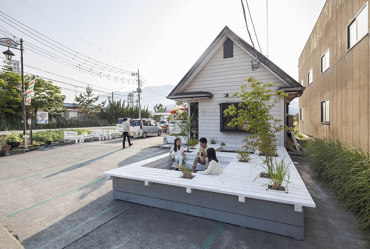 Relaxing wooden terrace reflects the design and appeal of the building next to it