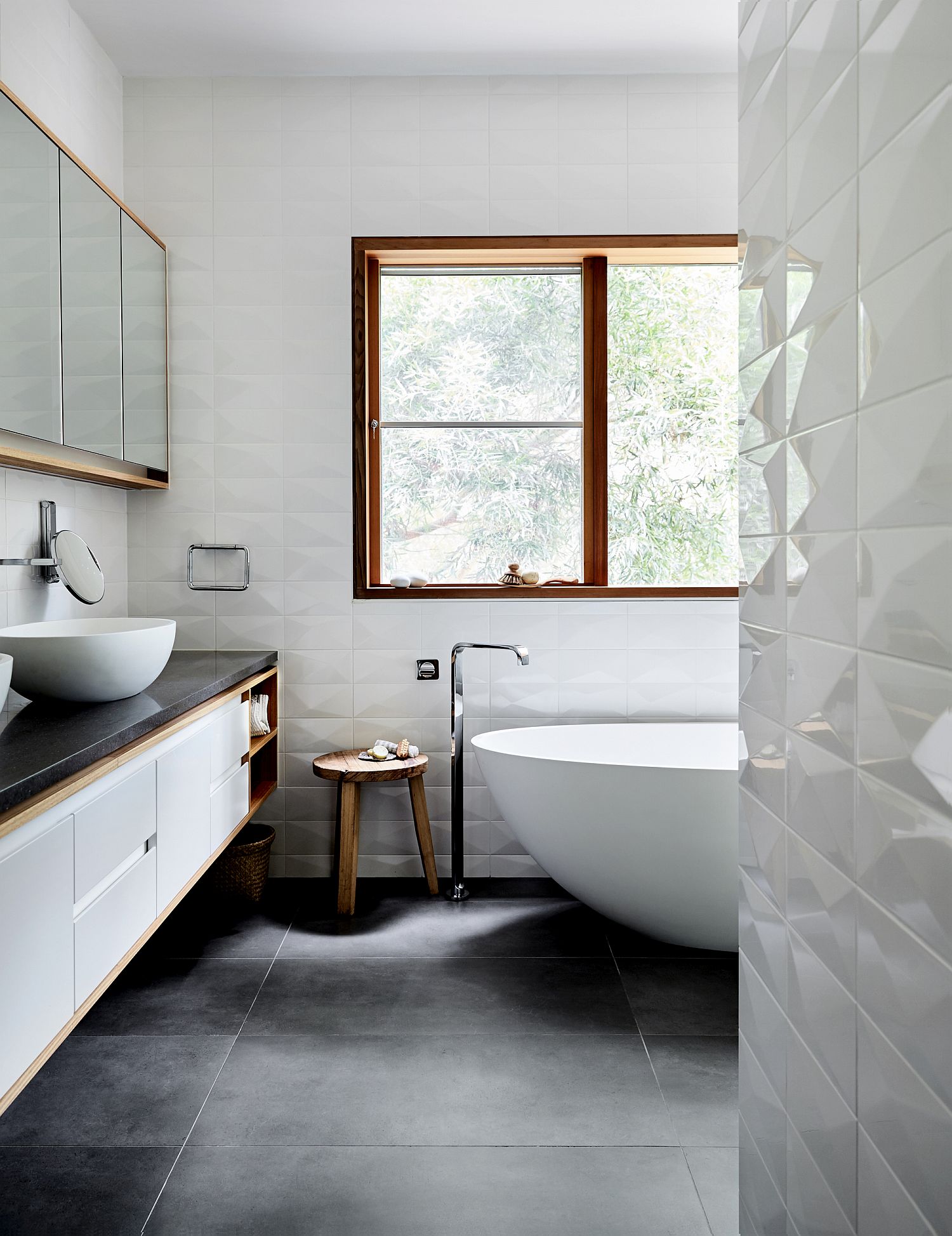 Textured white walls inside the bathroom with gray flooring