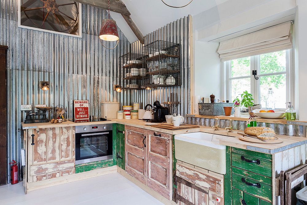 Unique kitchen with weathered wooden cabinets and metallic backdrop