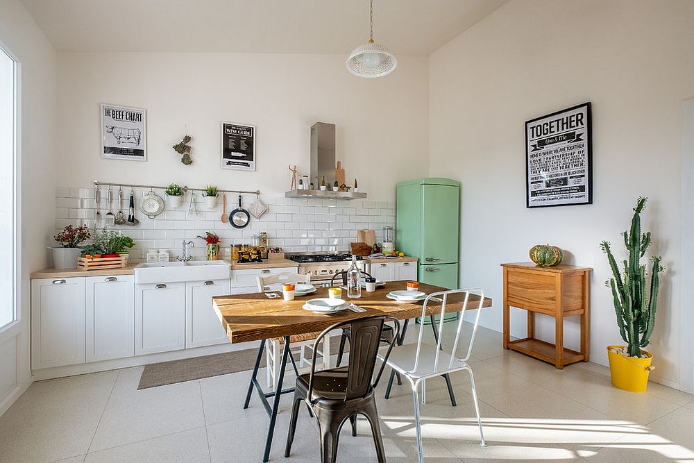 Vintage fridge in the corner adds to the farmhouse appeal of the kitchen in white