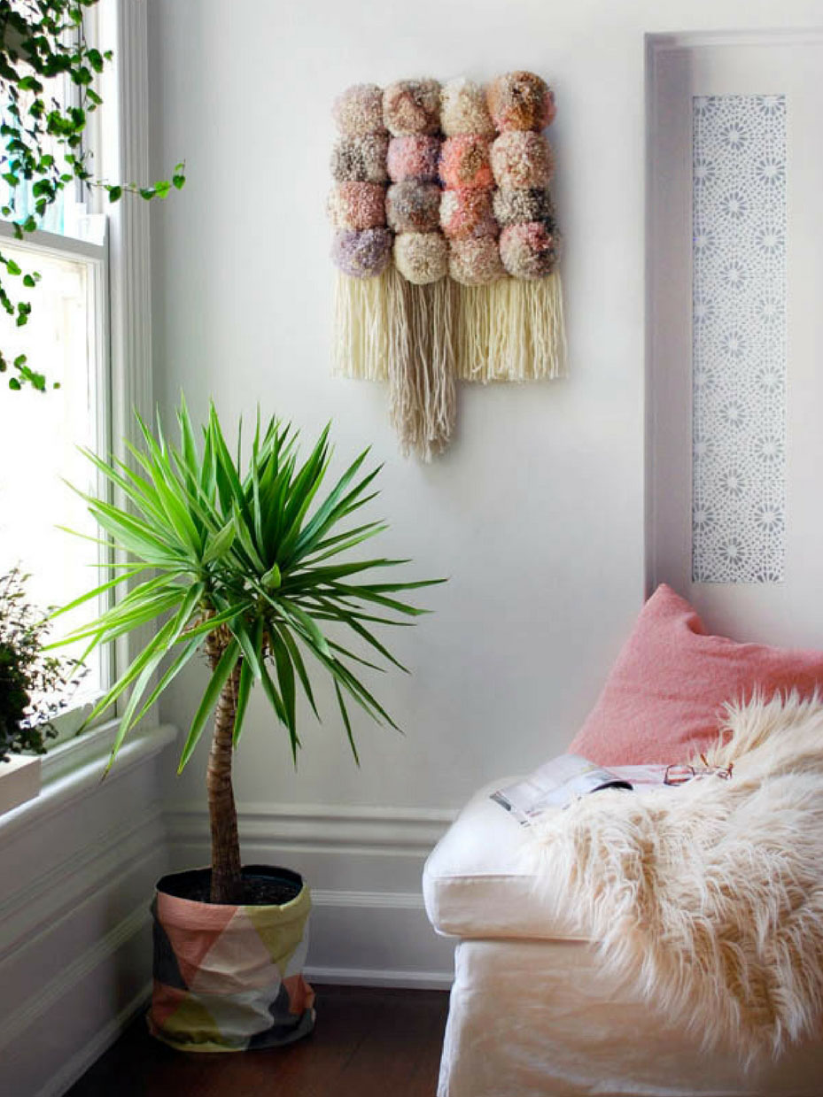 Wall hanging with large pom poms