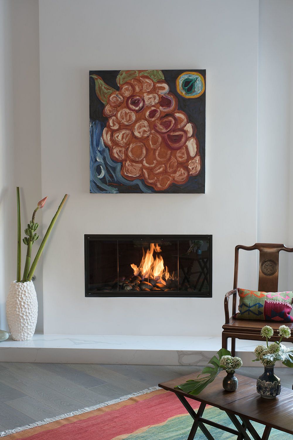White Plaster fireplace and marble hearth create a cozy focal point