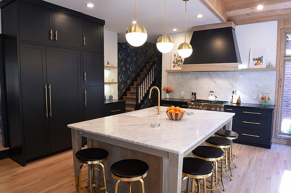 Black and gold bar stools along with kitchen cabinets and a central island in white