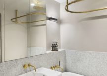 Brass-fixtures-add-golden-glint-to-the-bathroom-in-white-217x155