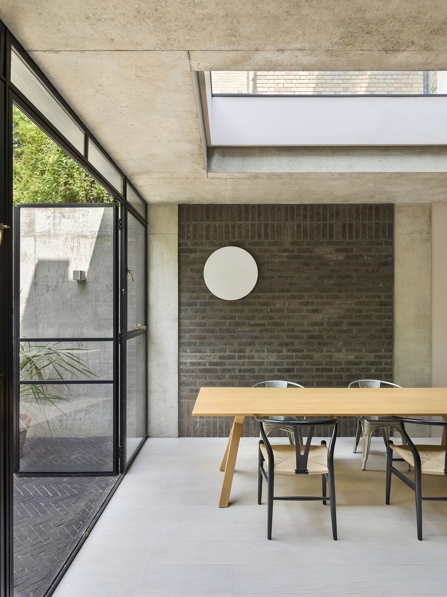 Brick wall section adds even more textural contrast to the dining area