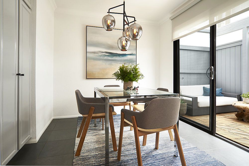 Dining area connected to the backyard in white and gray