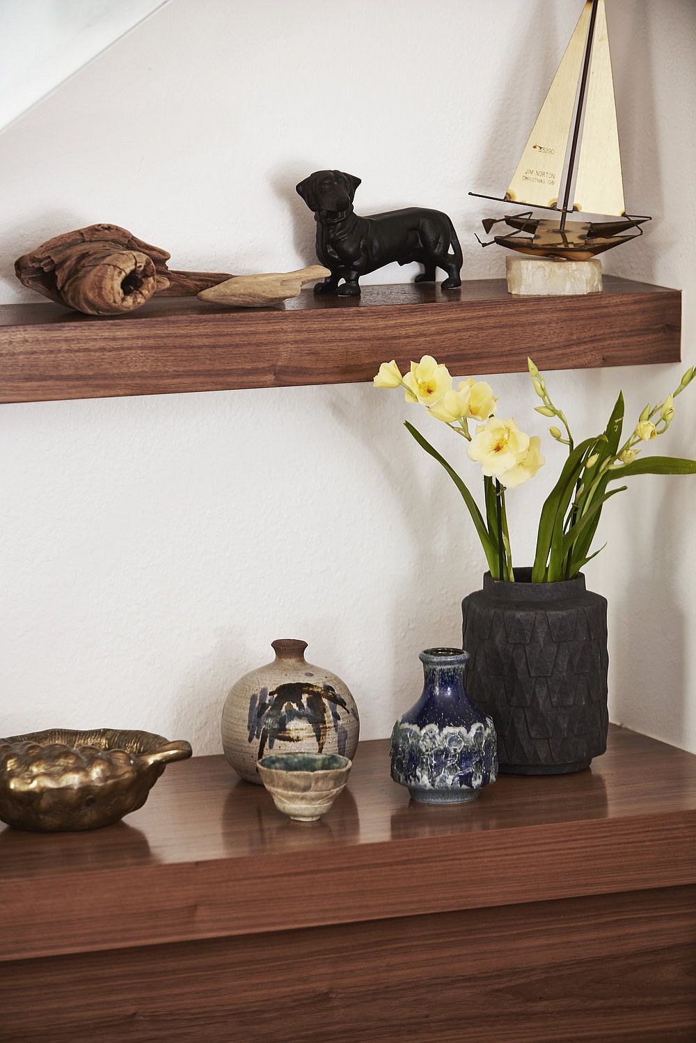 Floating wooden shelves and console under the stairway