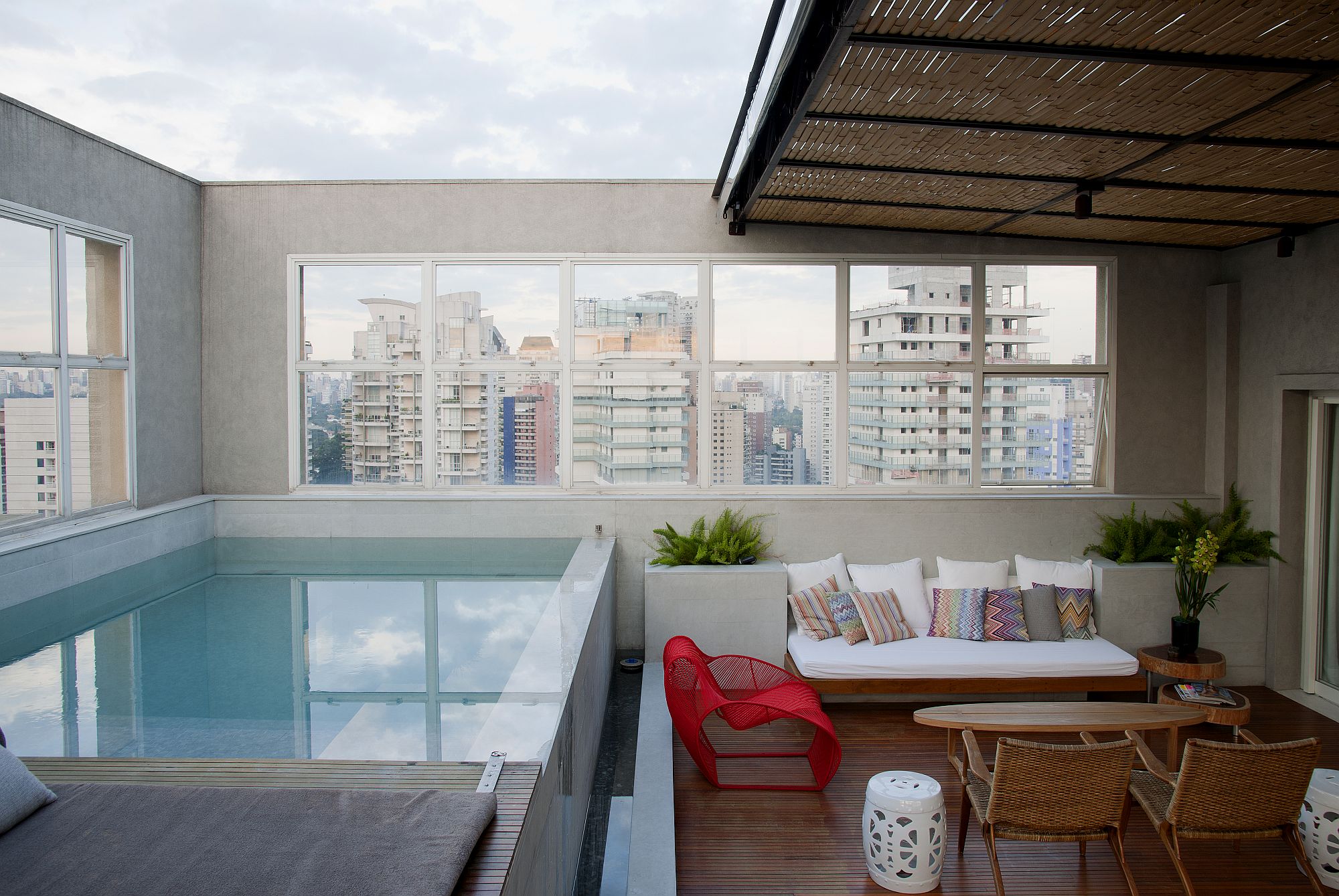 Infinity pool and deck area of the penthouse with view of the cityscape