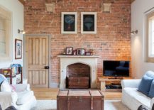 Large-farmhouse-style-living-room-with-brick-wall-and-giant-trunk-center-table-217x155