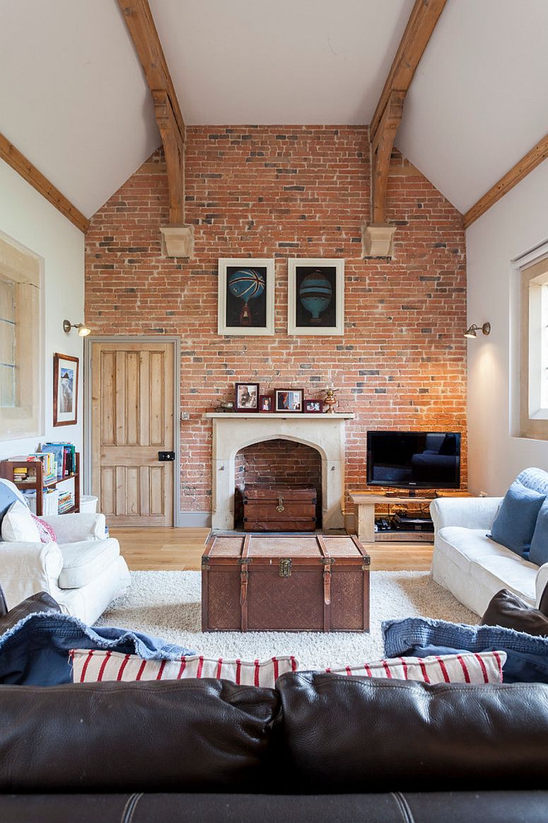 Large farmhouse style living room with brick wall and giant trunk center table