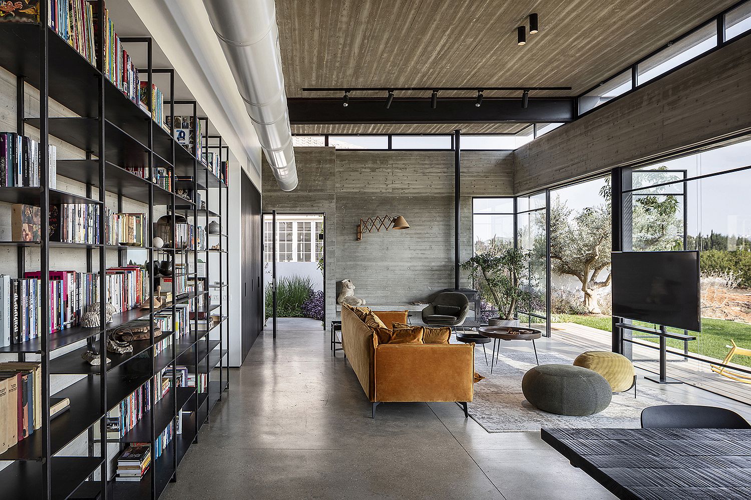 Metal pipes and minimal bookshelf acts unique appeal to the living space