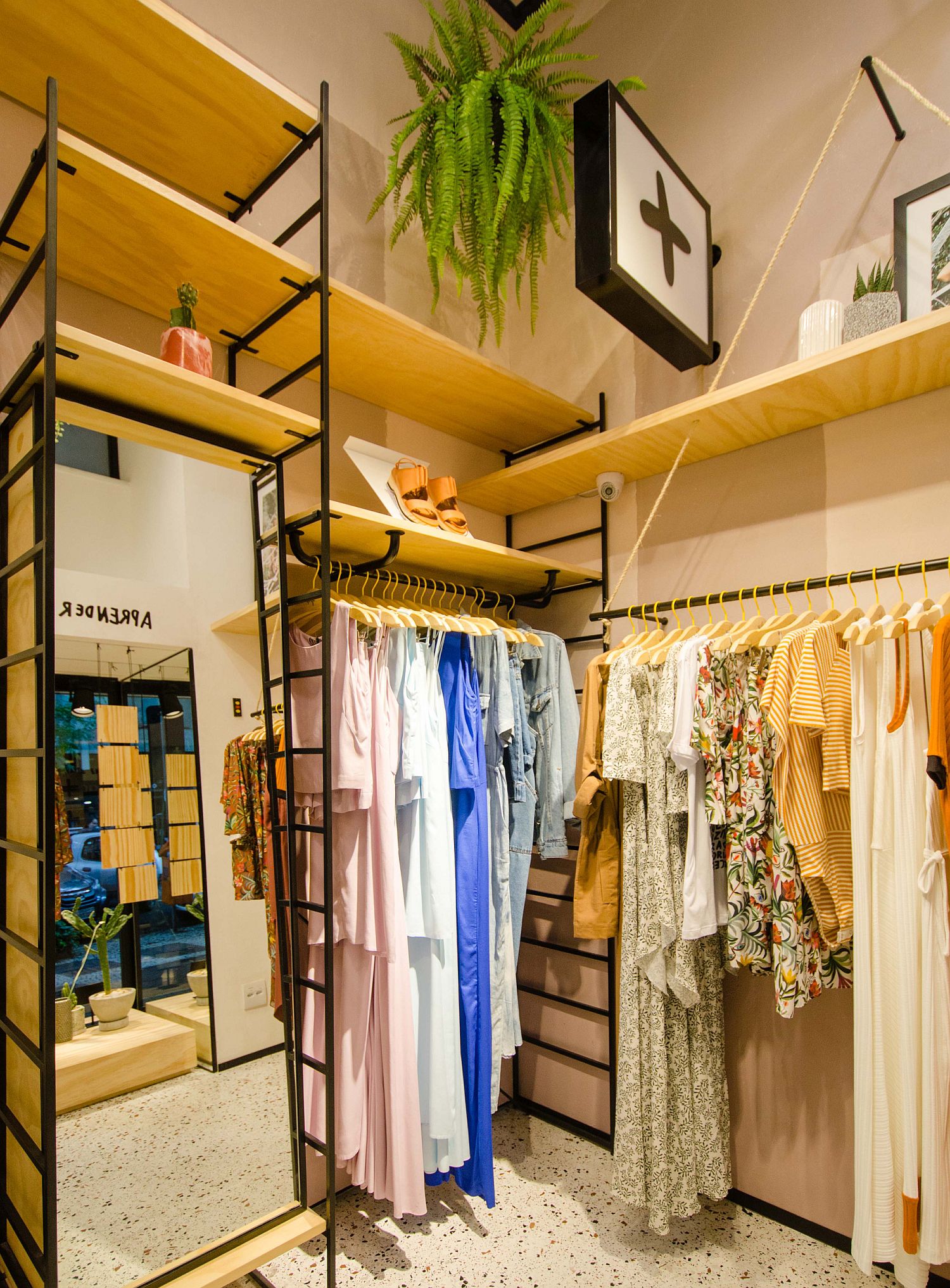 Metal, wood and greenery shape the interior of the store