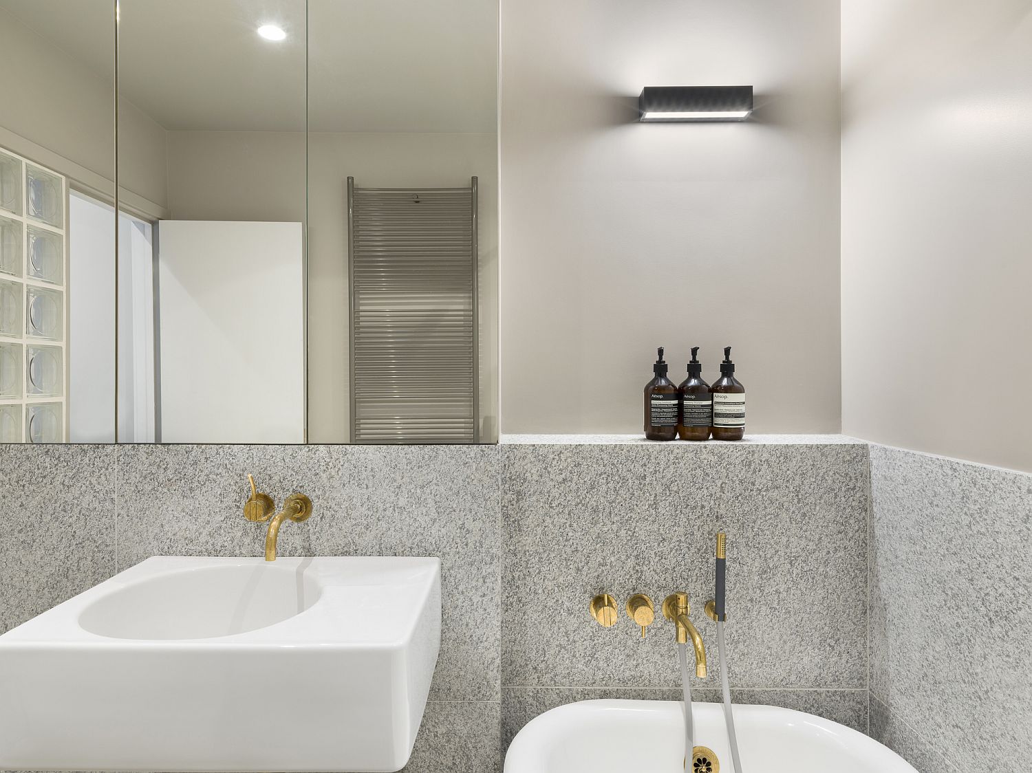 Metallic glint brings brightness to this modern bathroom in white and gray