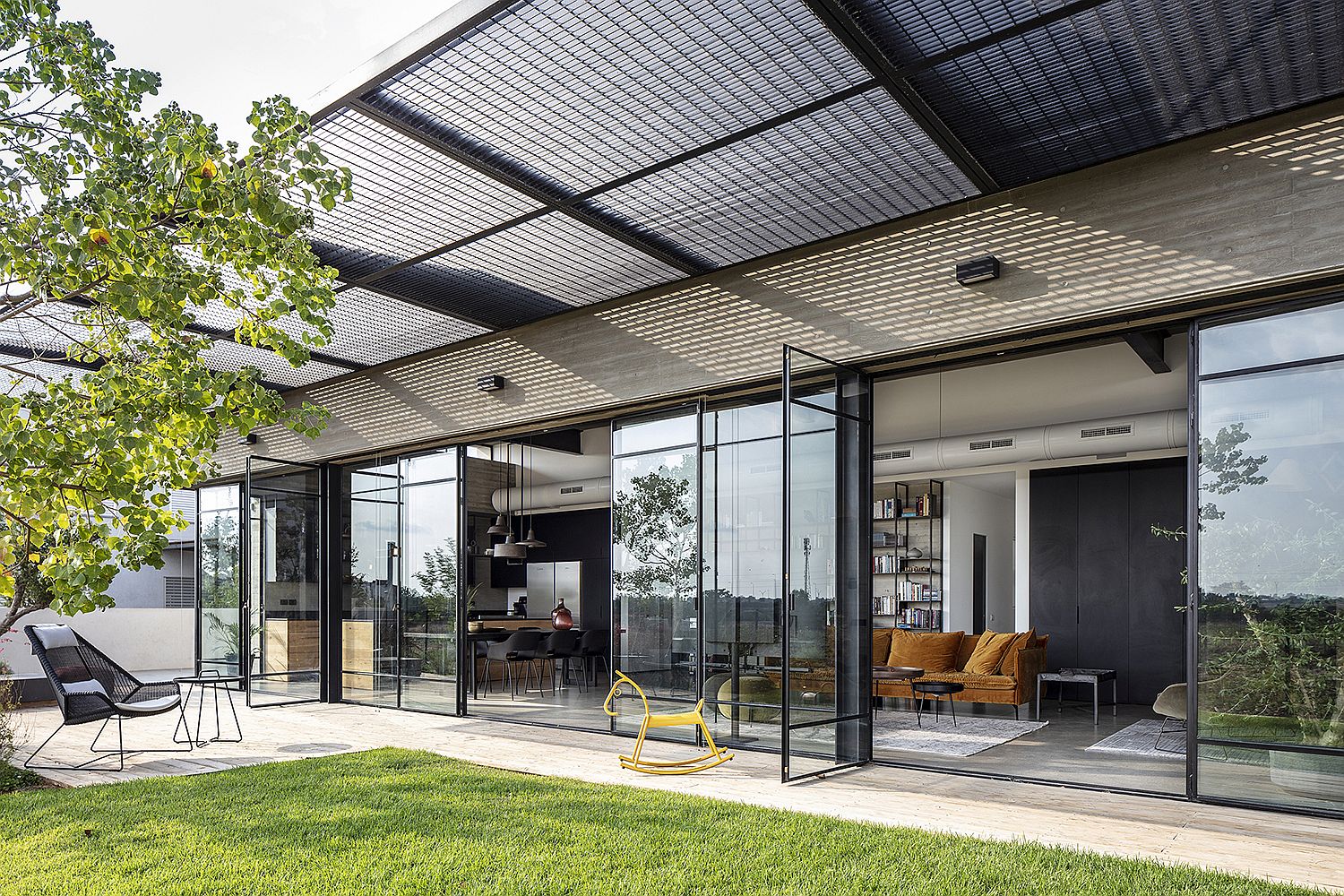 Metallic mesh pergola outside the living area provides necessary shade