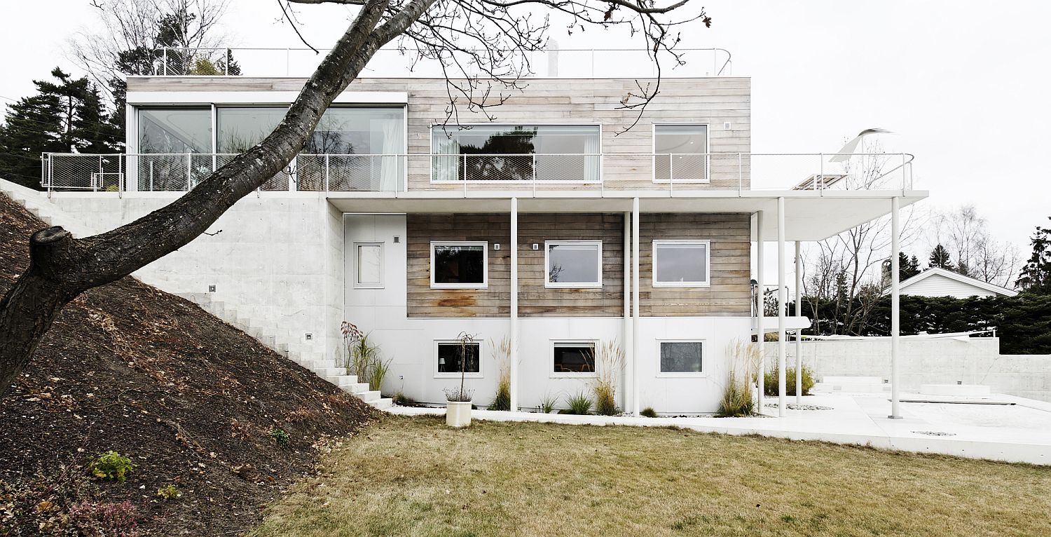 Multi-level modern hillside home in concrete and wood