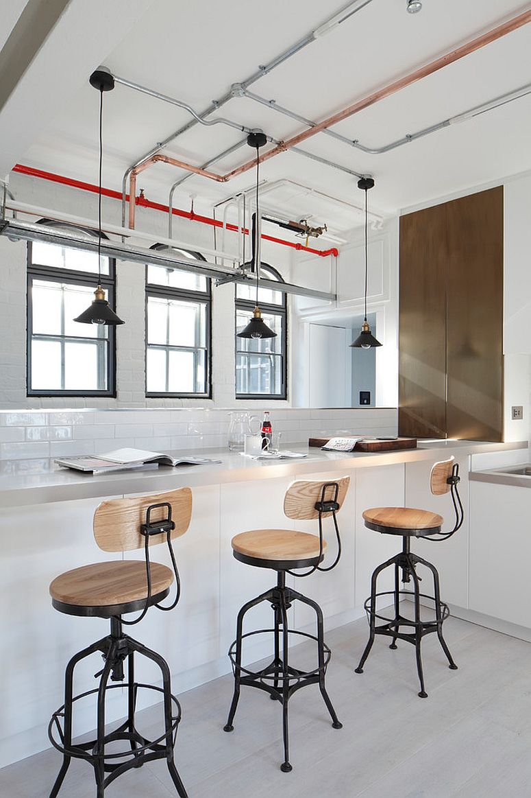 Polished industrial kitchen with bar stools that match its style