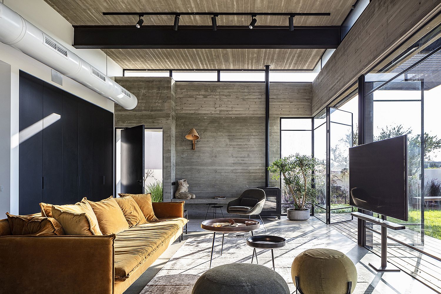 Sweeping central living area of the home with kitchen and dining next to it