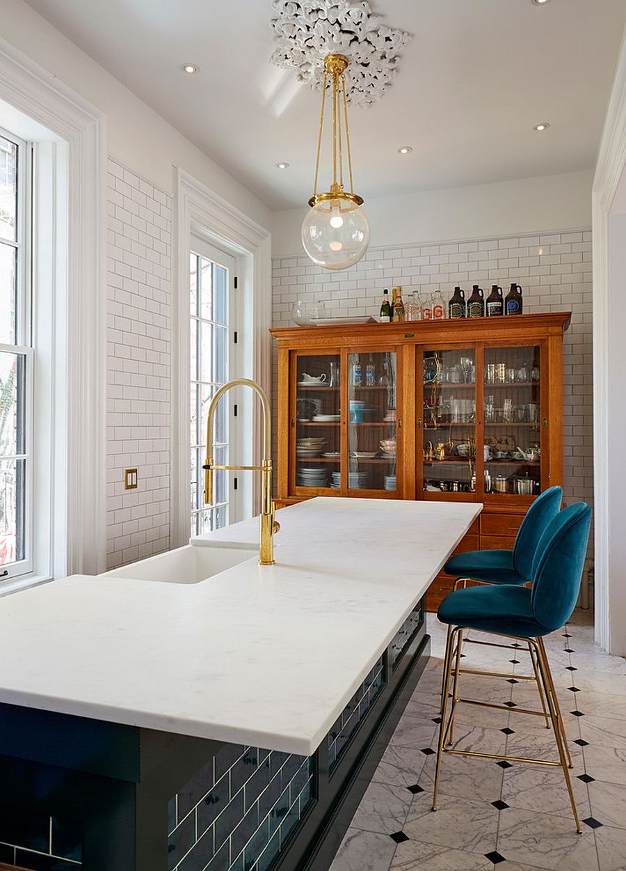 Transitional-kitchen-in-white-with-blue-and-gold-bar-stools-along-with-pendants-and-fixtures-in-gold